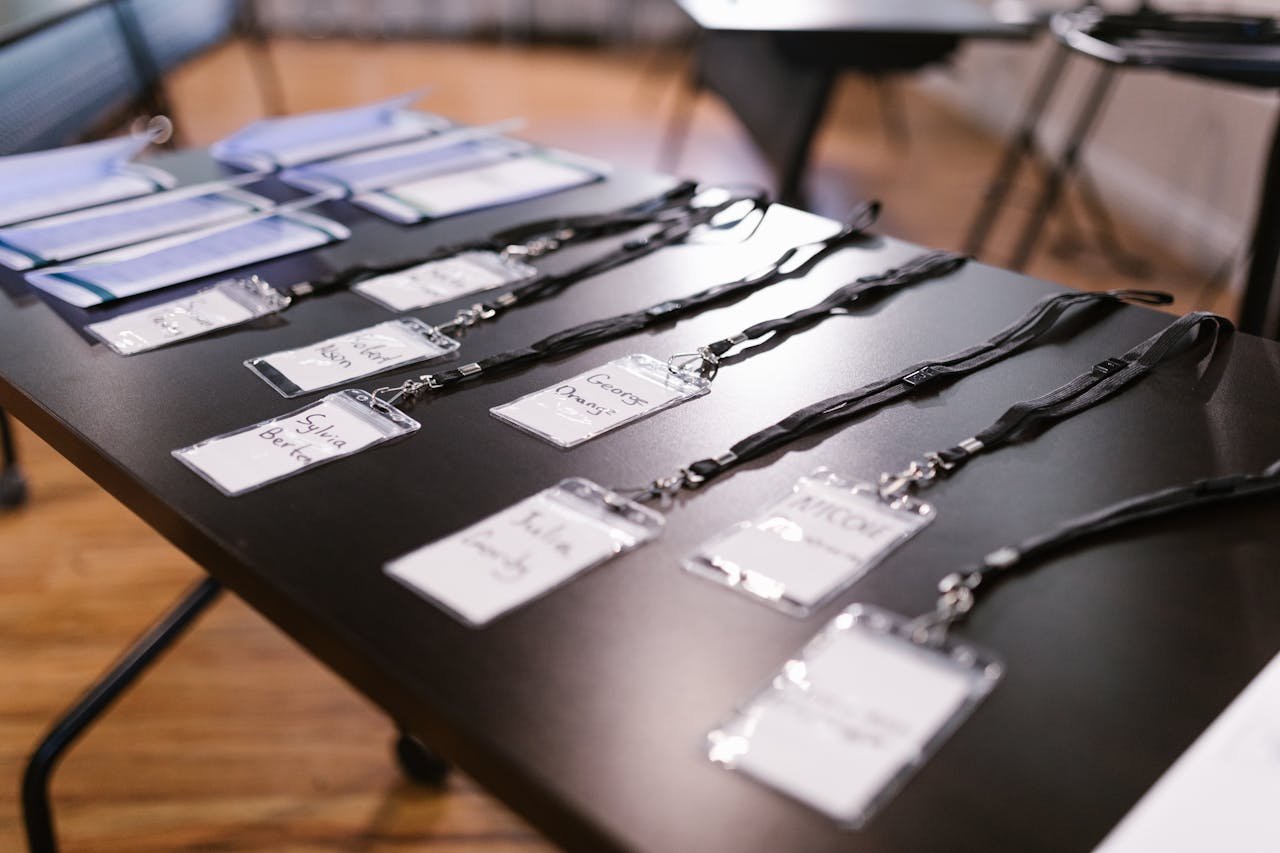 get-in-touch Close-up of name tags and folders laid out for a conference or meeting.